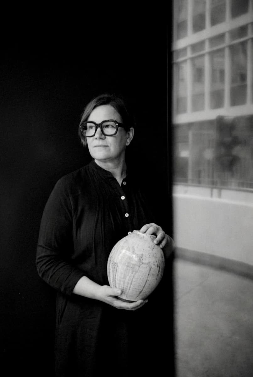 Julia Martin holding one of her ceramic vases